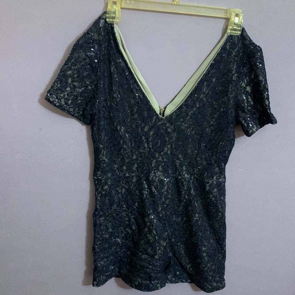 Navy blue sequin shorts romper for a petite woman.